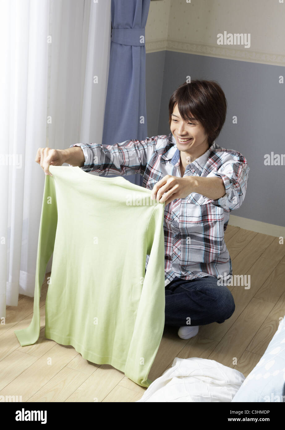 Man folding laundry Stock Photo Alamy
