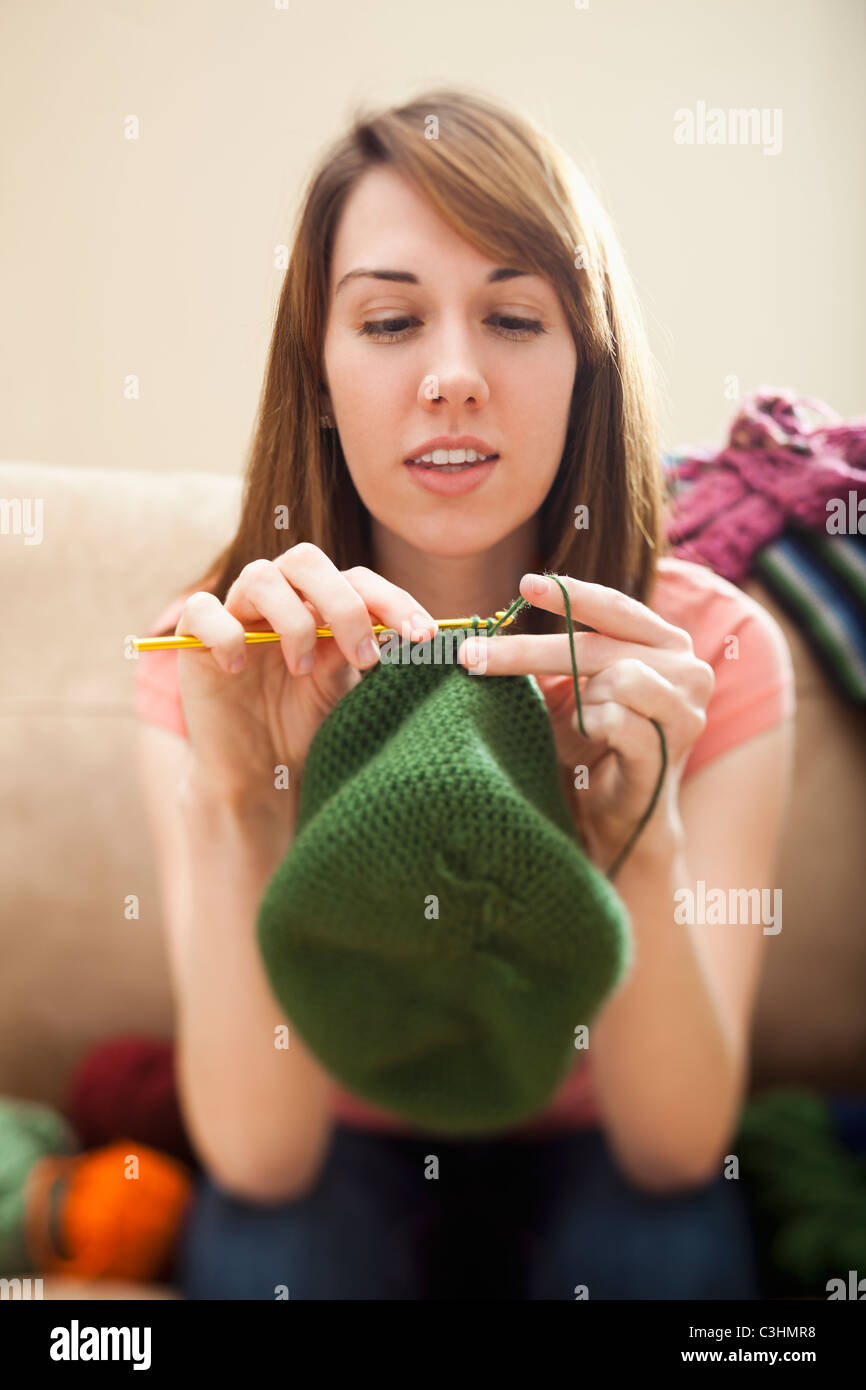 Young woman knitting woolly hat Stock Photo Alamy