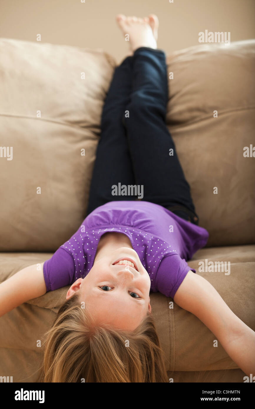 Barefoot girl lying on sofa hi-res stock photography and images - Alamy
