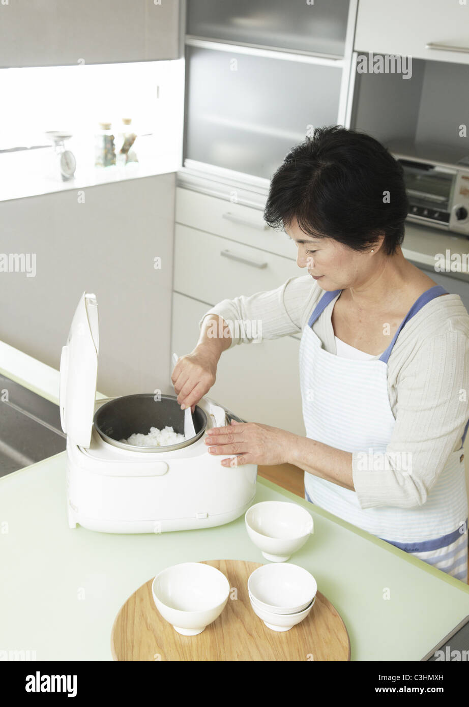 Woman serving rice Stock Photo Alamy
