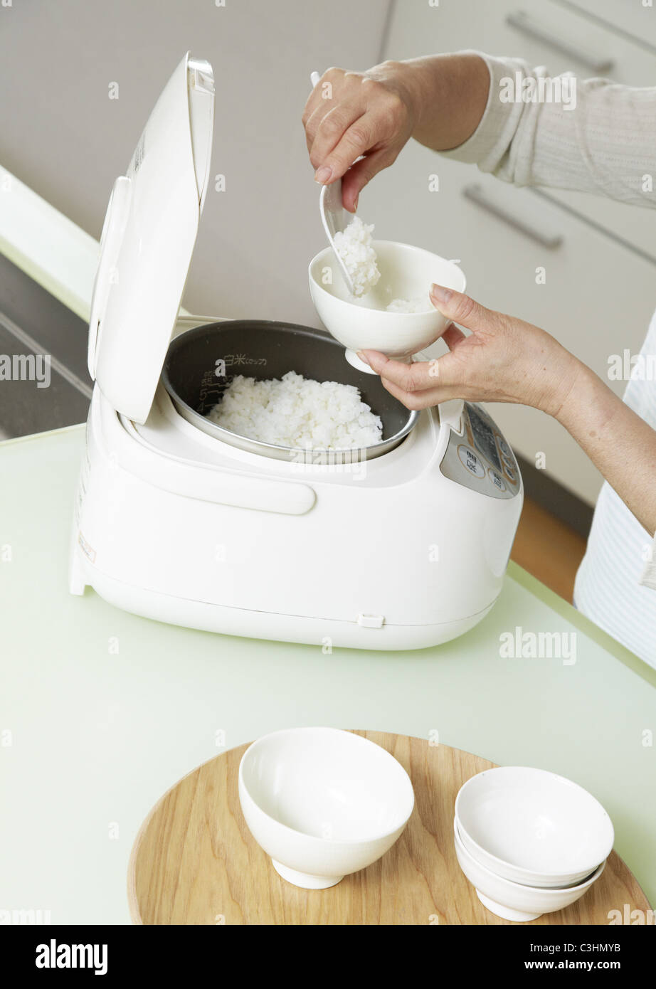 Woman's hands serving rice Stock Photo Alamy