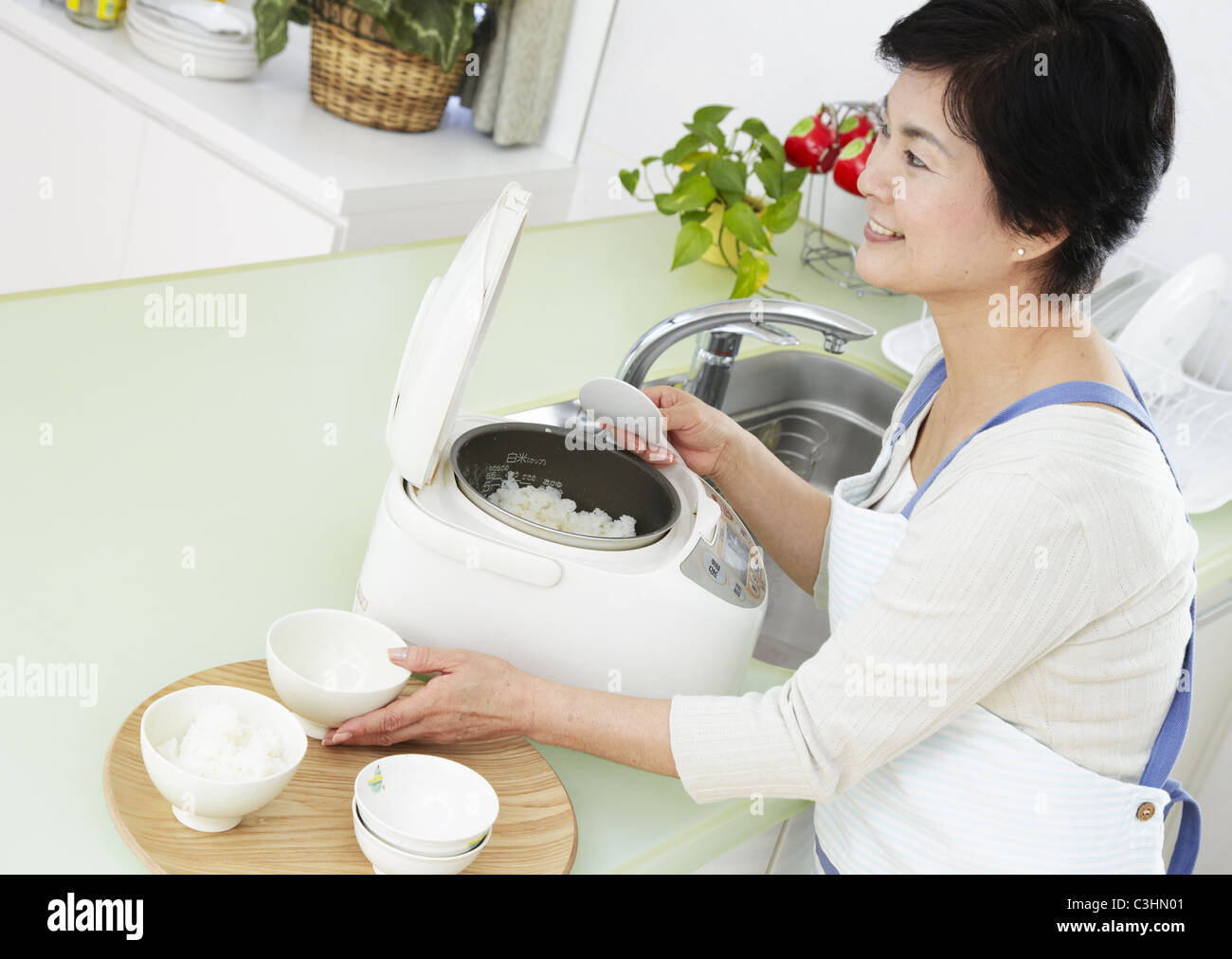 Woman serving rice Stock Photo Alamy
