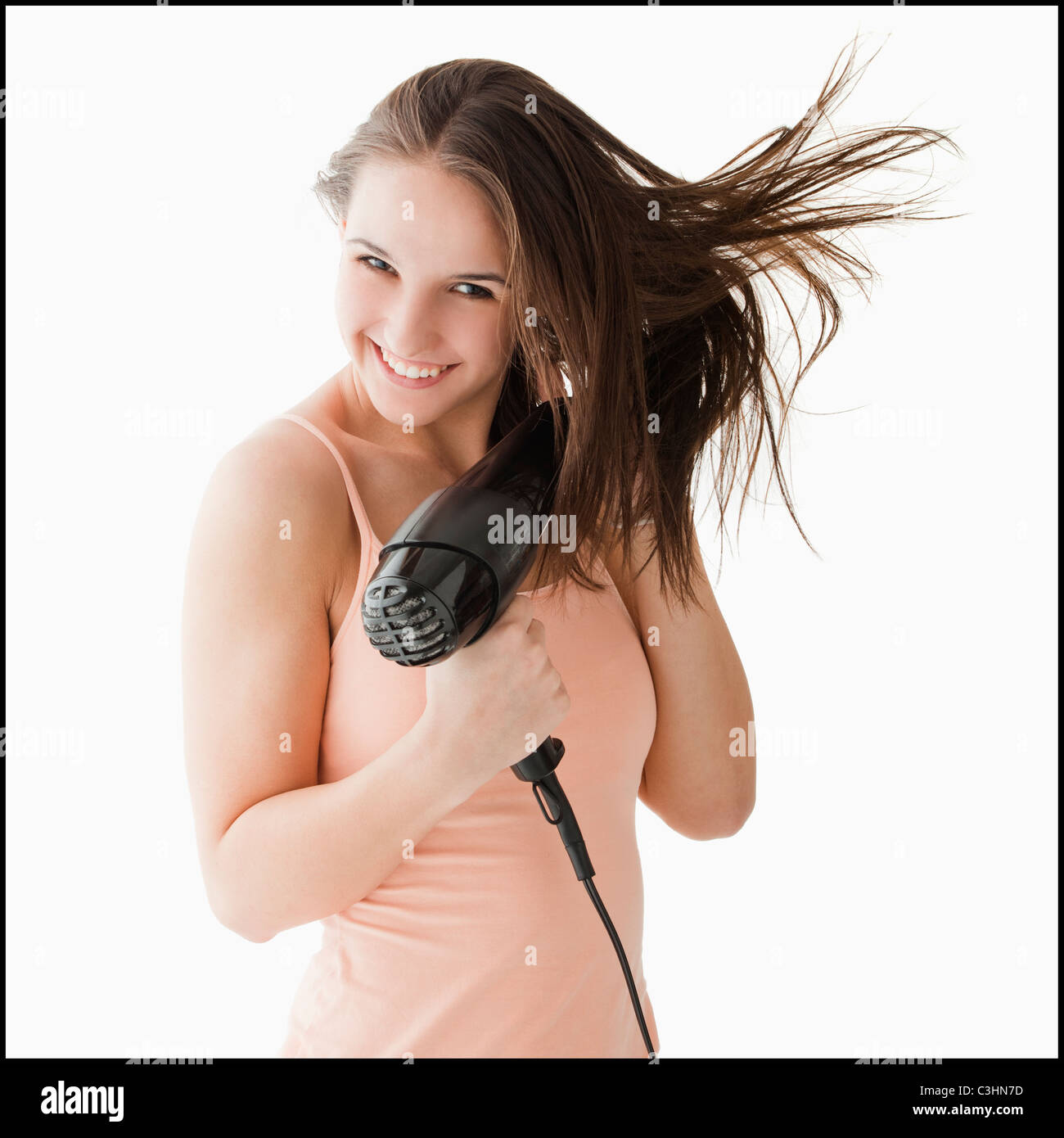 Woman blow drying hair hi-res stock photography and images - Alamy