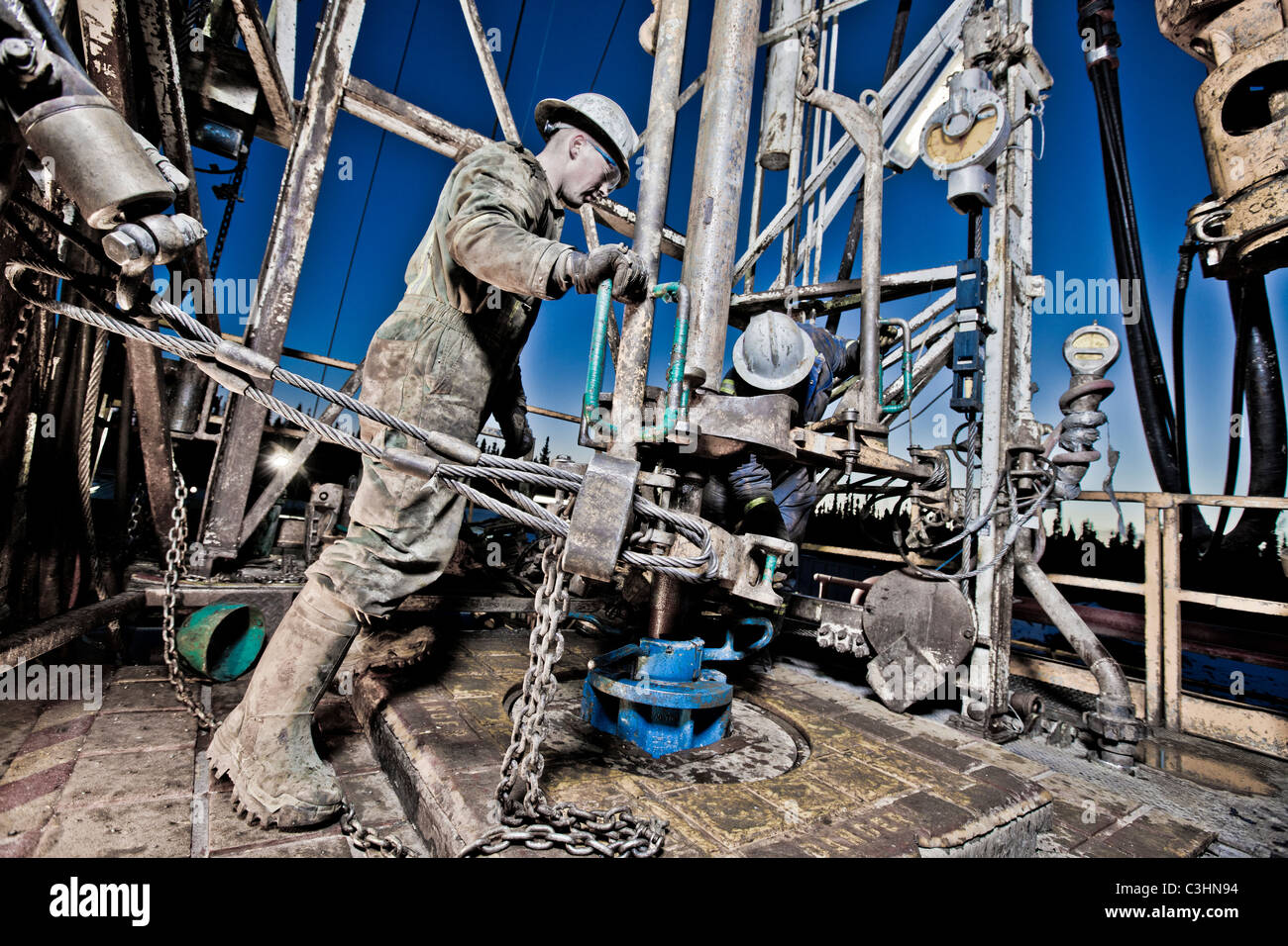 Oil workers using oil drill Stock Photo
