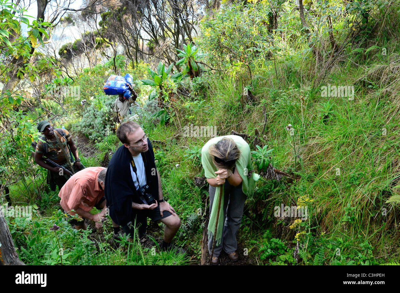 Exhausted hikers on Nyiragongo active volcano in the Alpine region of Virunga National Park, Democratic Republic of Congo. Stock Photo