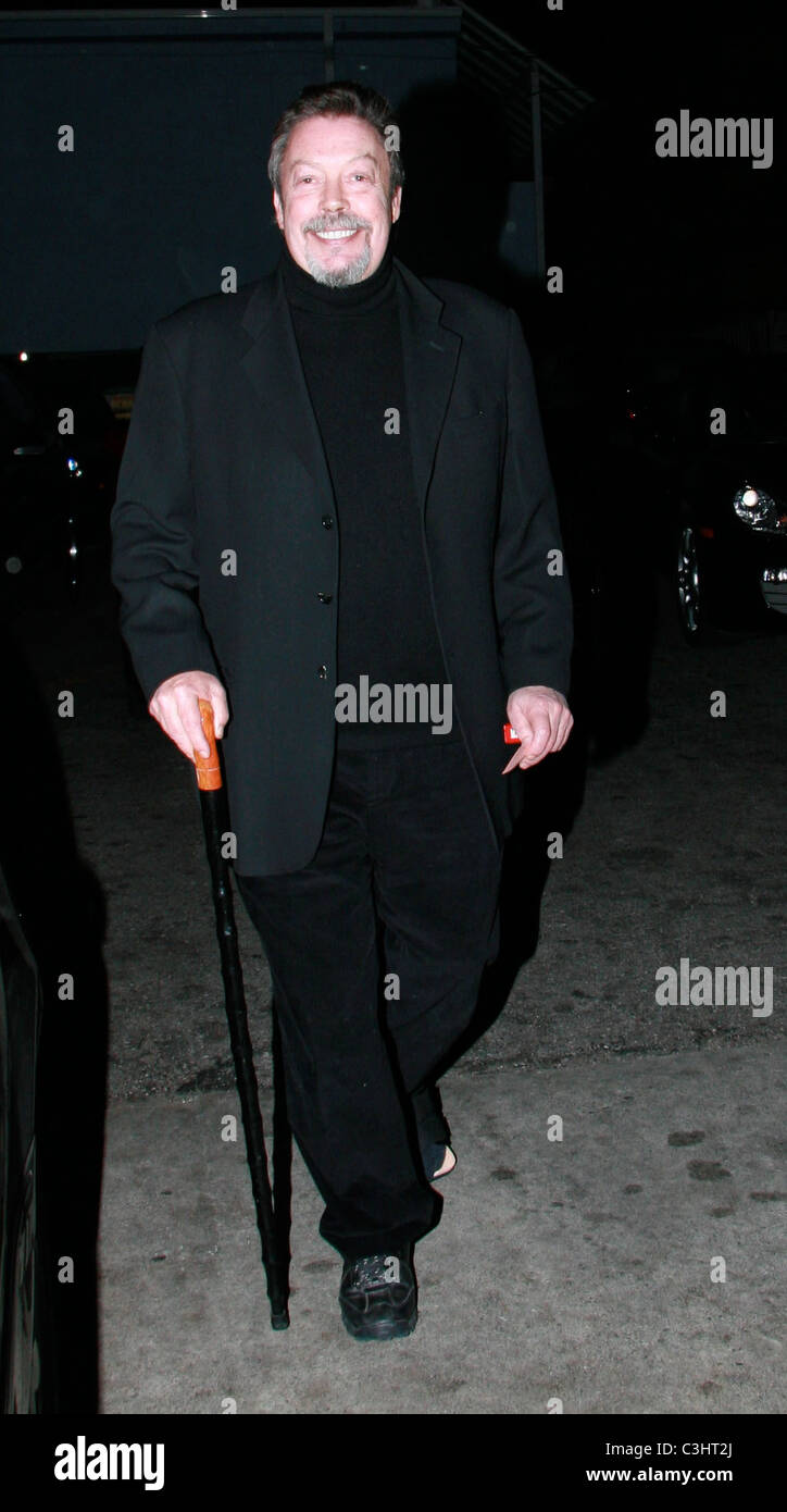 Tim Curry leaves Orso restaurant in West Hollywood with the help of a