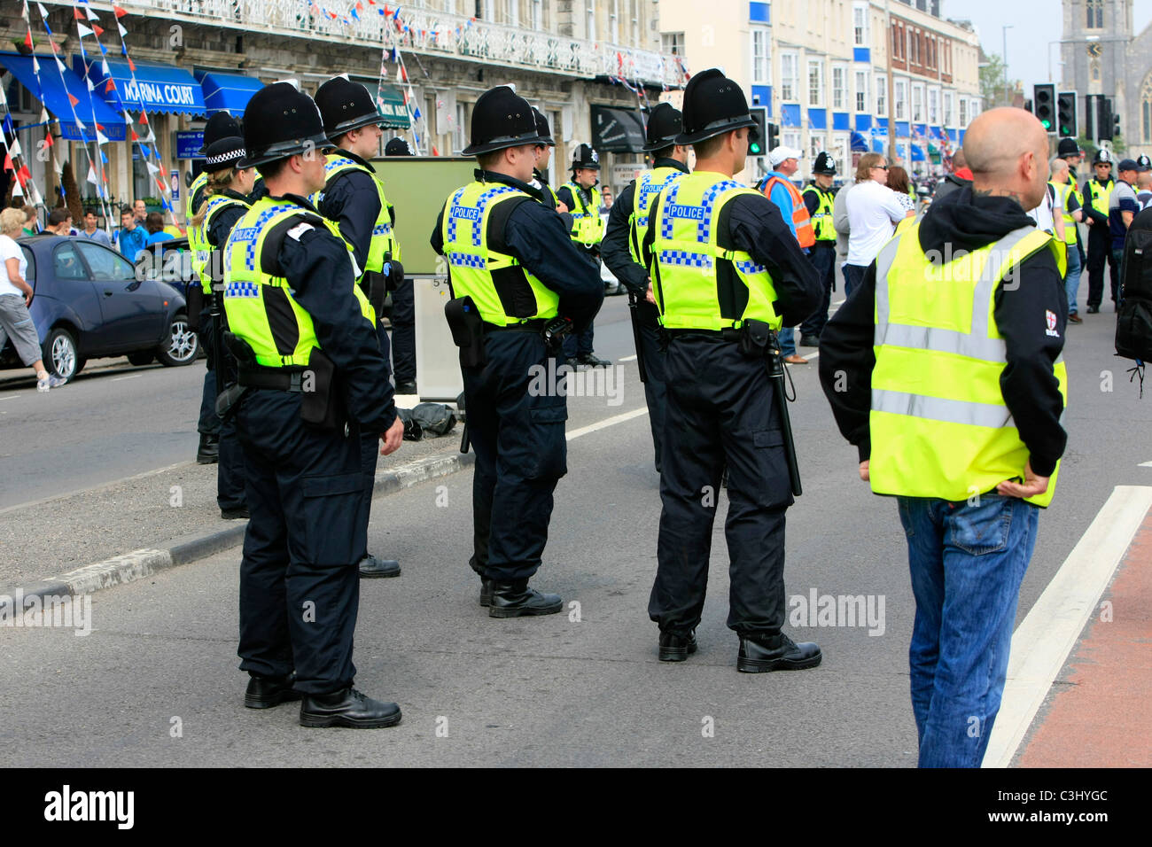 Police officers in hivis vests and protest marshals at an EDL