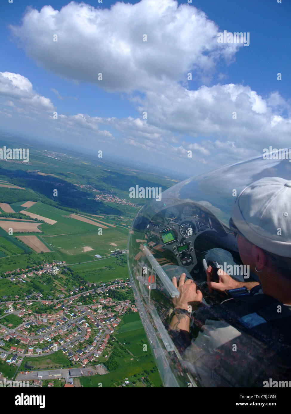 Glider plane cockpit view over Sarreguemines town and airfield