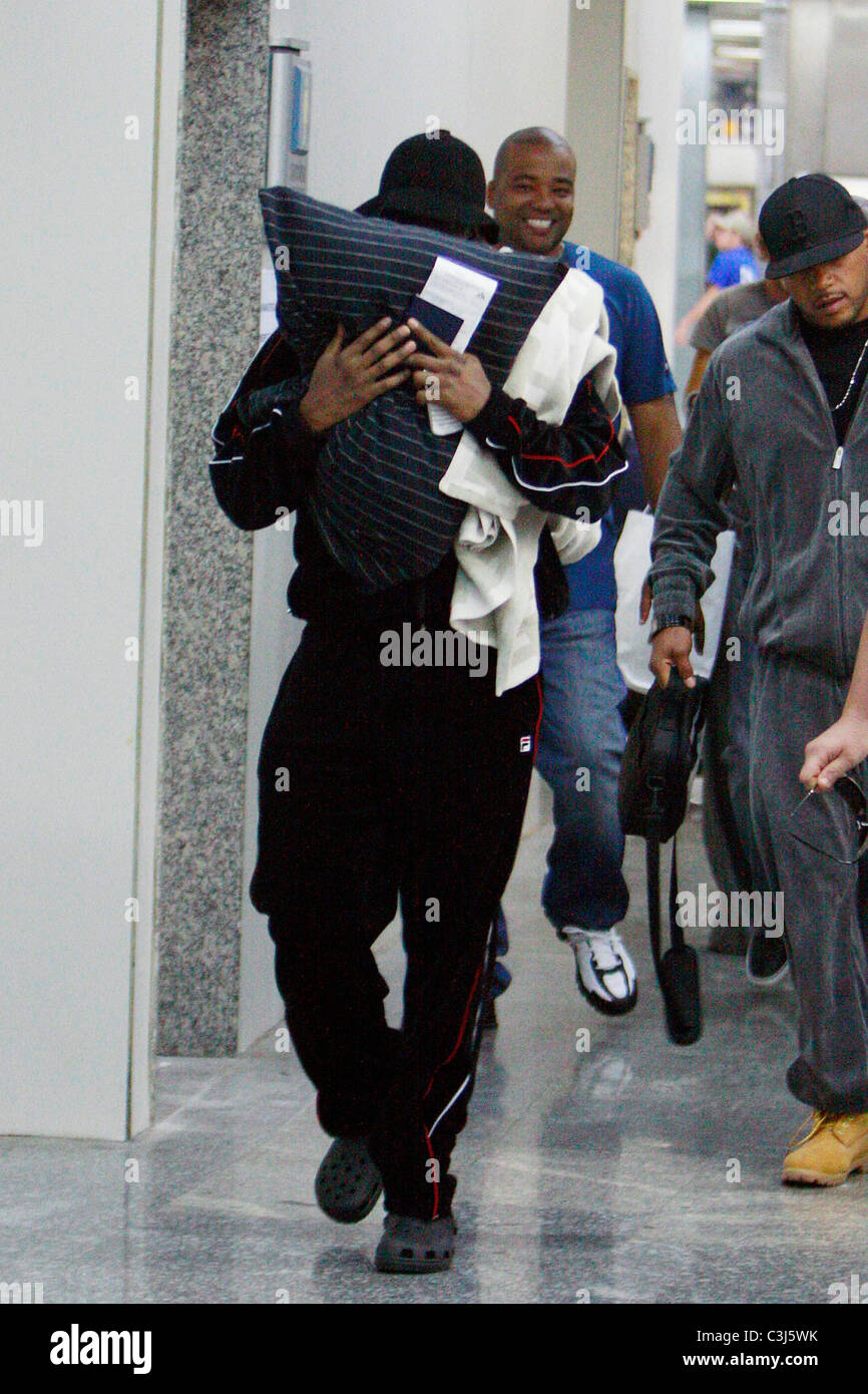 Sean Combs, aka Diddy, covers his face with a pillow to avoid being
