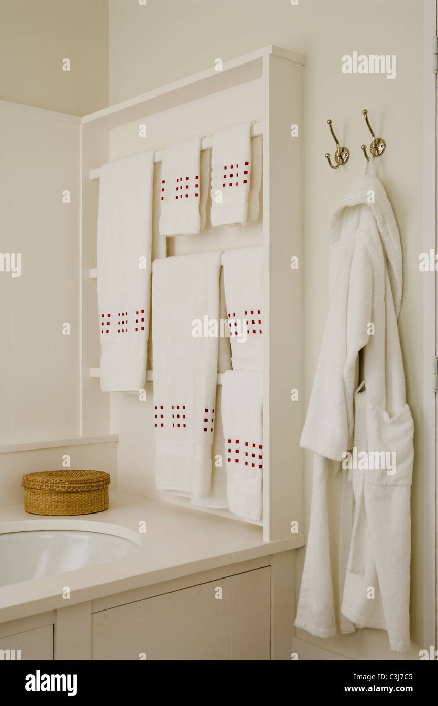 White toweling robe and towels in bathroom Stock Photo
