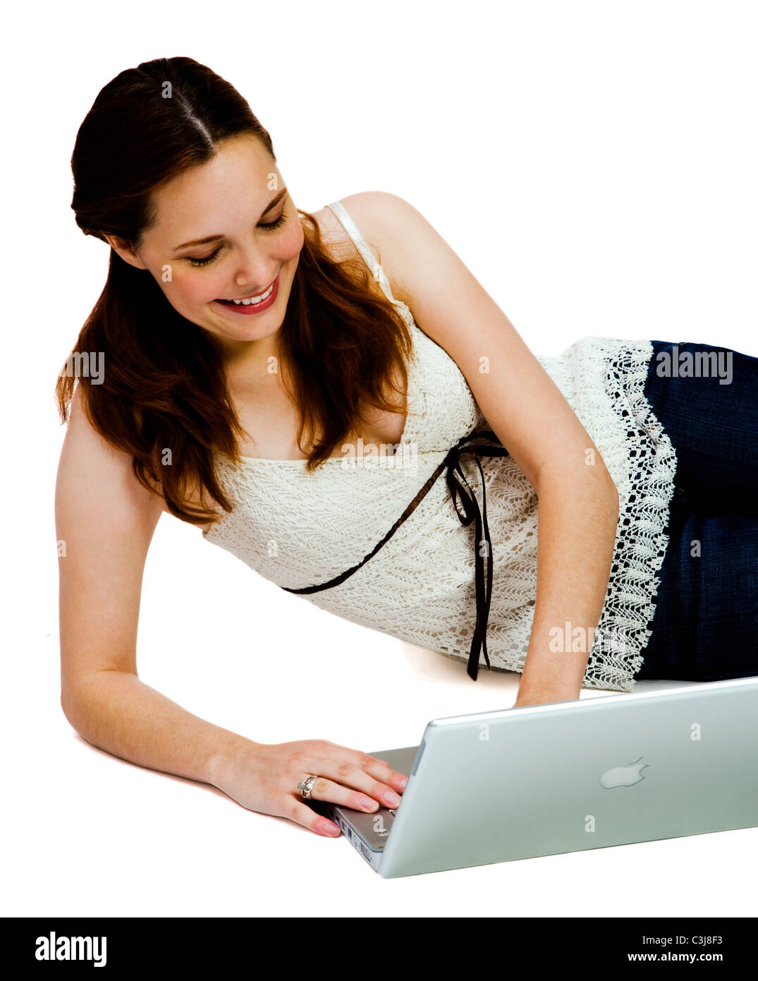 Smiling young woman using a laptop isolated over white Stock Photo - Alamy