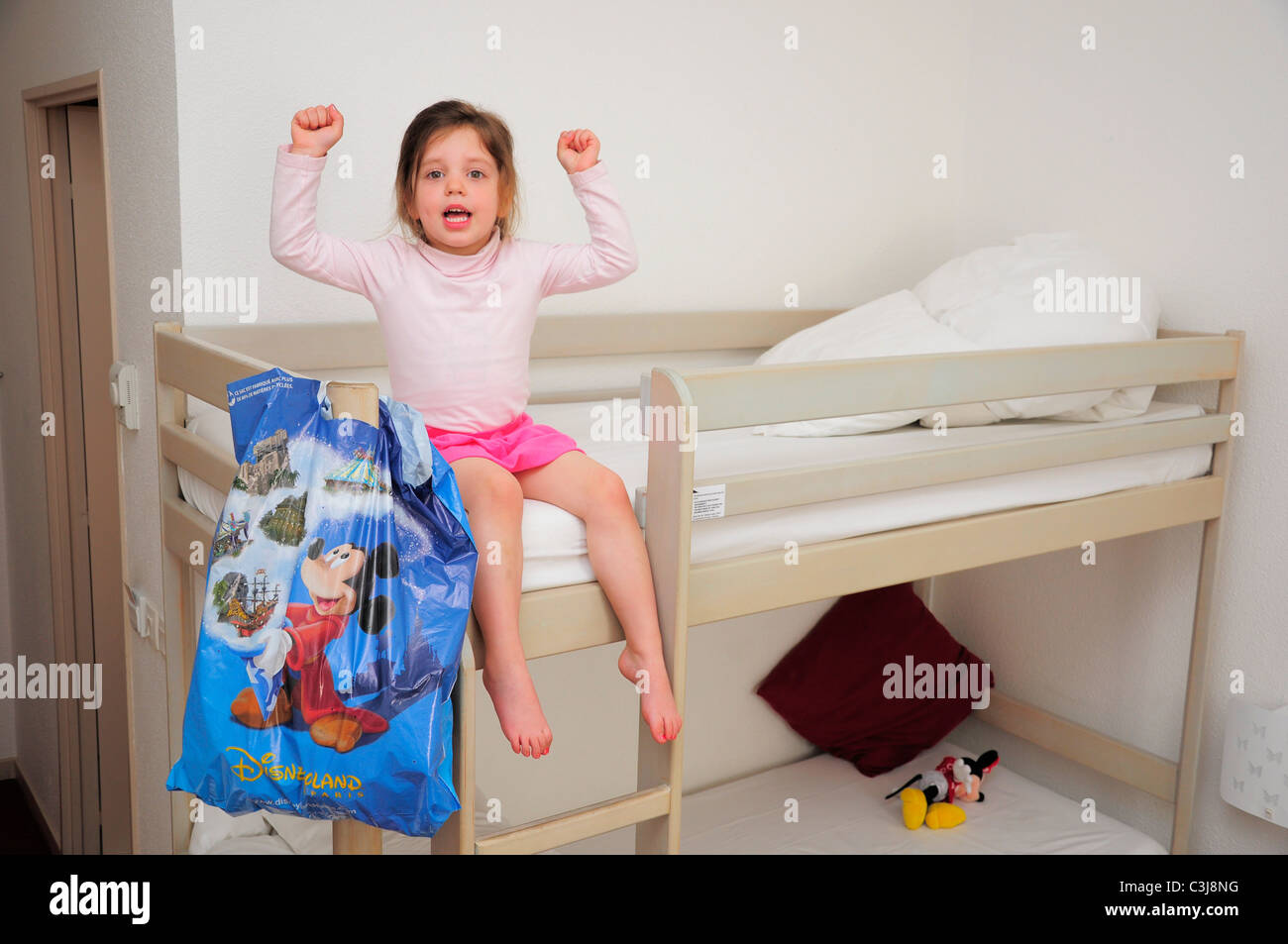 Young child excited to be visiting Disneyland Paris. Stock Photo