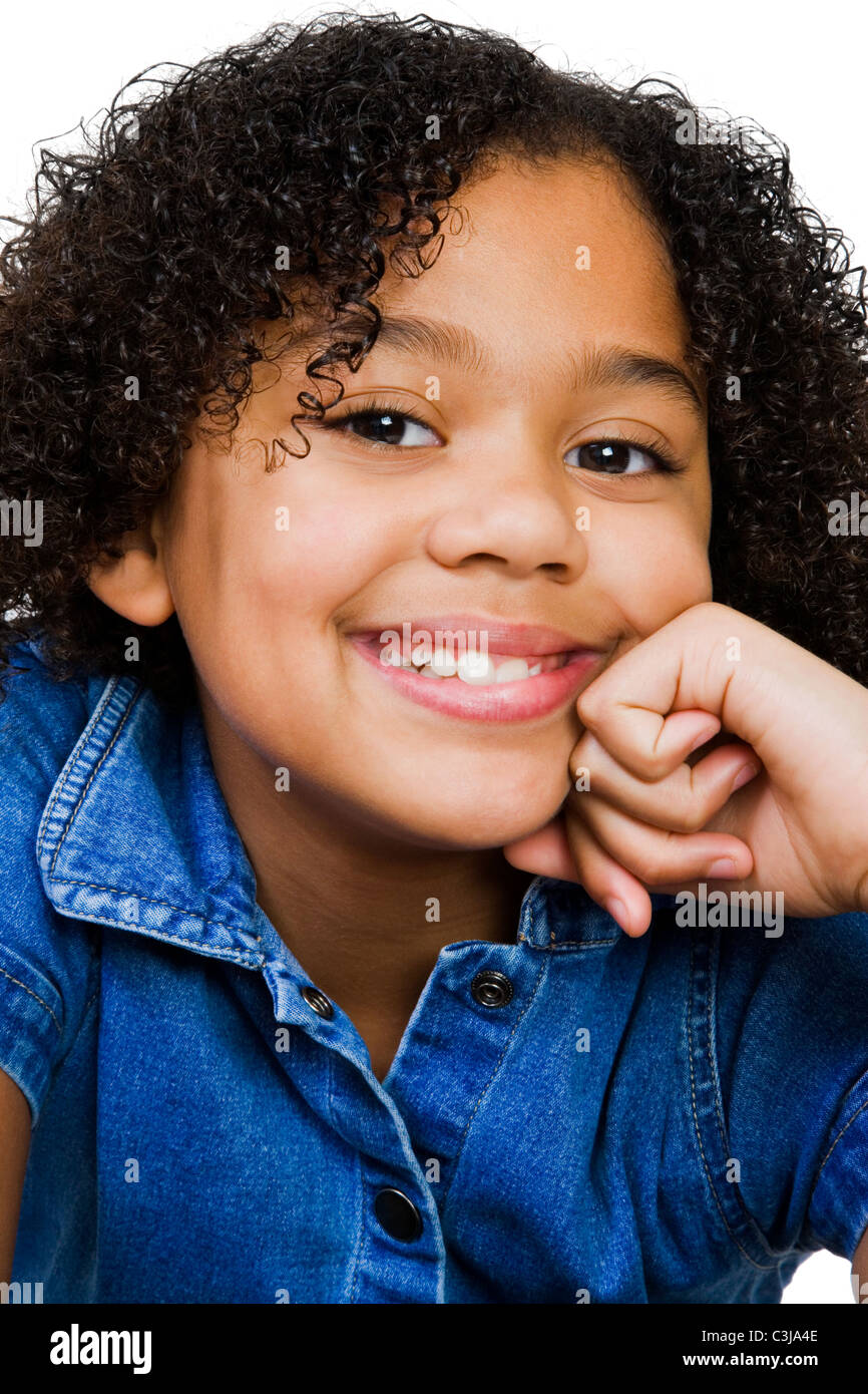 Girl smiling with her hand on chin isolated over white Stock Photo - Alamy