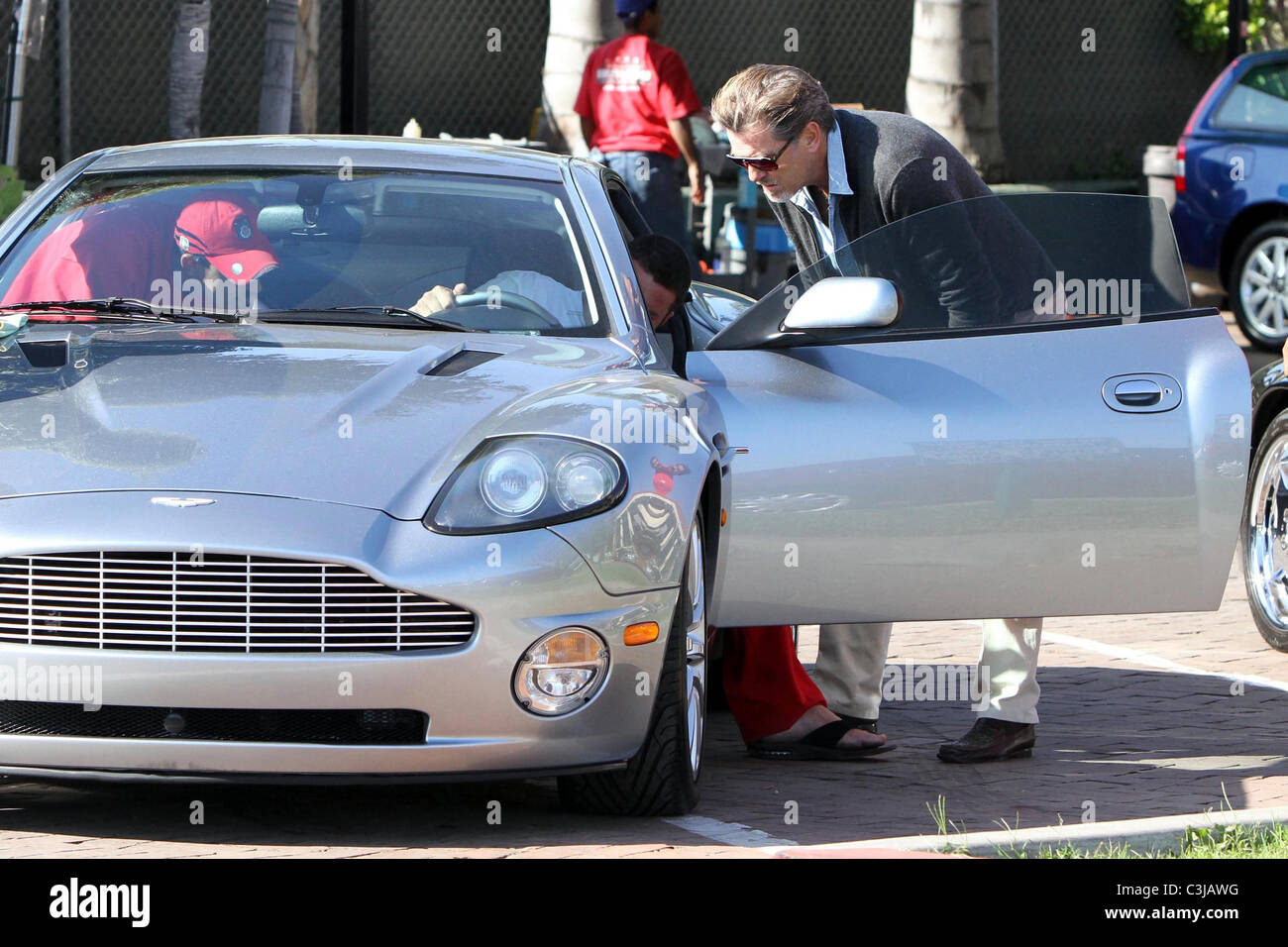Pierce Brosnan picks up his gleaming Aston Martin from the car wash at