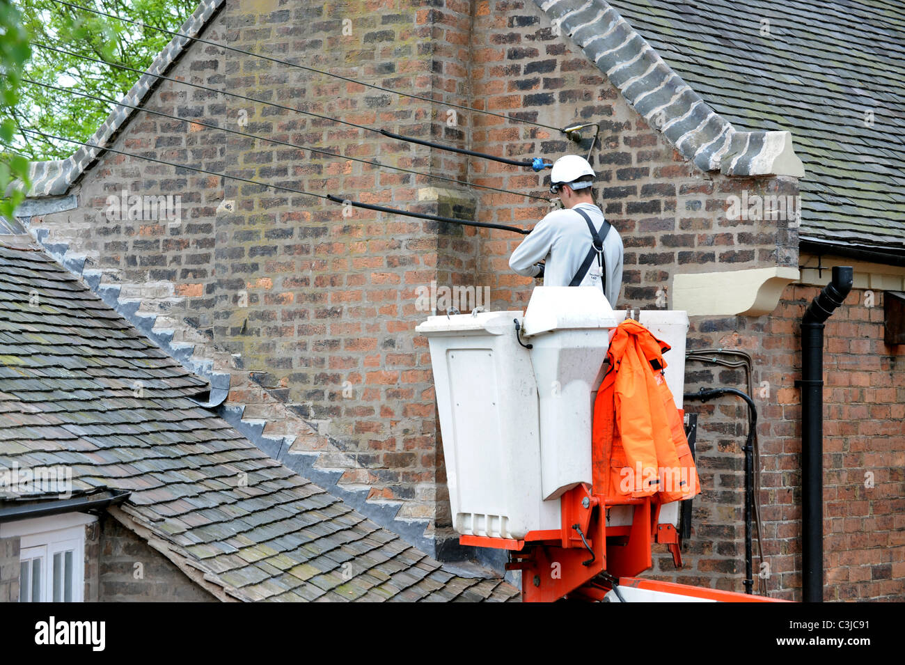 Electrical conractor repalcing old external cables on old house UK