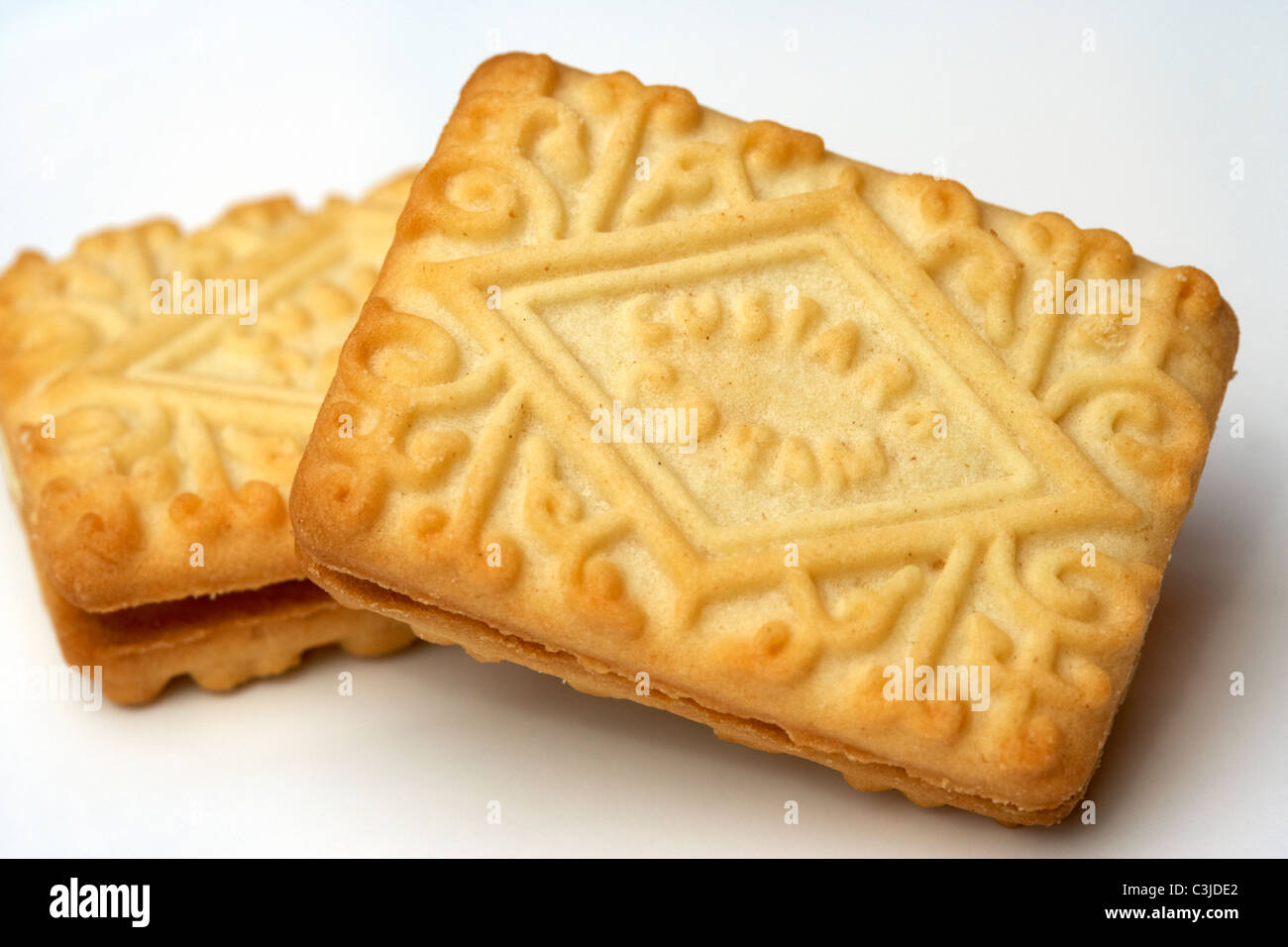 custard cream biscuits on a white plate Stock Photo Alamy