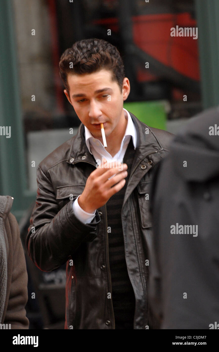 Shia LaBeouf smokes a cigarette on the set of his new movie 'Wall Street 2:  Money Never Sleeps' New York City, USA - 16.11.09 Stock Photo
