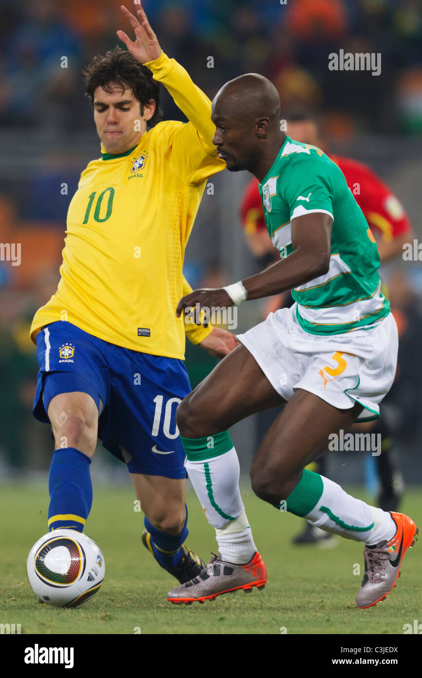 Kaka of Brazil (l) and Didier Zokora of Côte d'Ivoire (r) vie for the ball during a FIFA World Cup football match June 20, 2010. Stock Photo