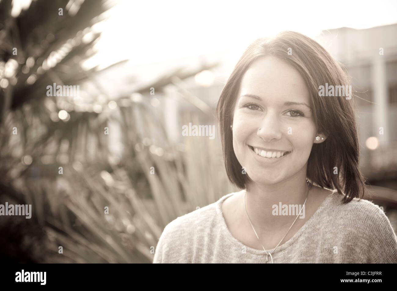 Portrait of smiling young woman outdoors Stock Photo - Alamy