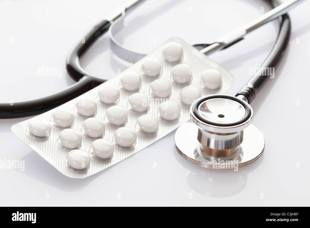 Tablet with stethoscope on white background Stock Photo - Alamy