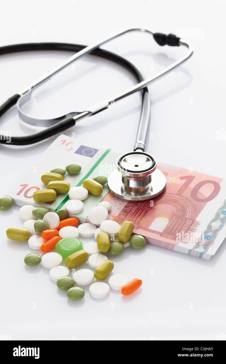 MIxed tablets with bundle of 10 euro note and stethoscope Stock Photo