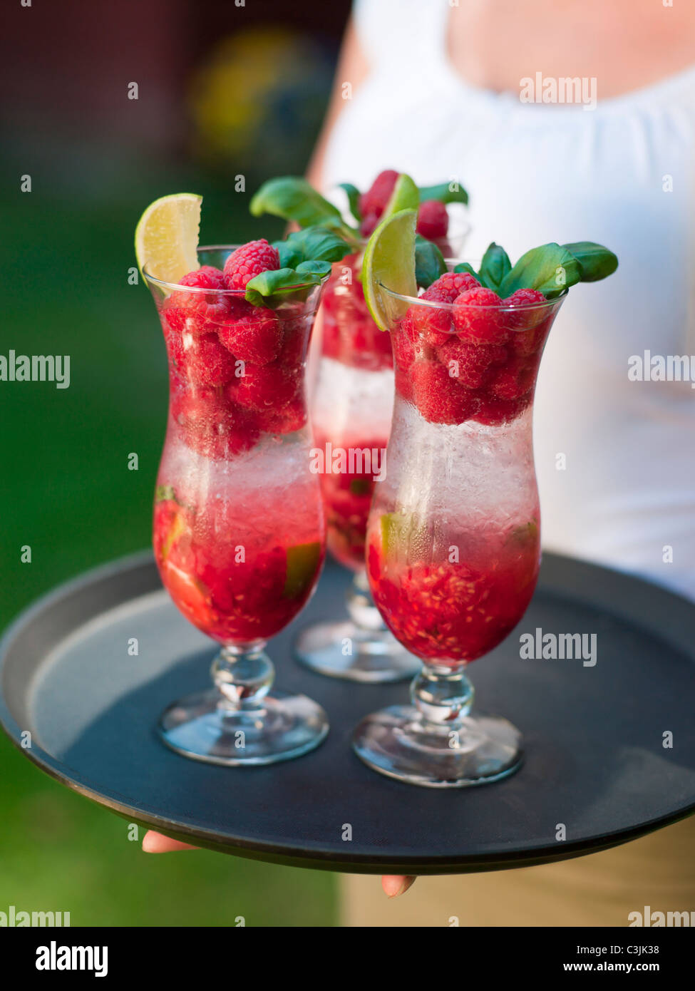 Person holding tray with glasses of cocktail Stock Photo