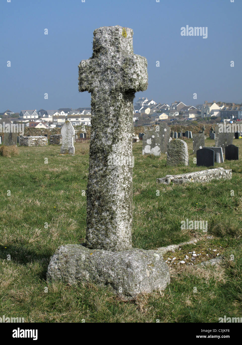 Lichen covered granite stoner cross in a churchyard, Tintagel, Cornwall, March Stock Photo