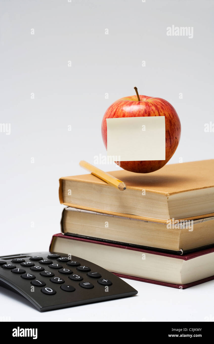 An apple on a stack of books, close-up. Stock Photo