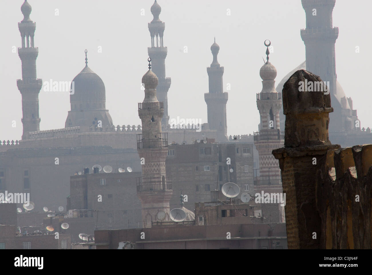 A corner of the Mosque of Ibn Tulun (lower right) with the minarets of Rifa'ai and Sultan Hassan mosques in the background. Stock Photo