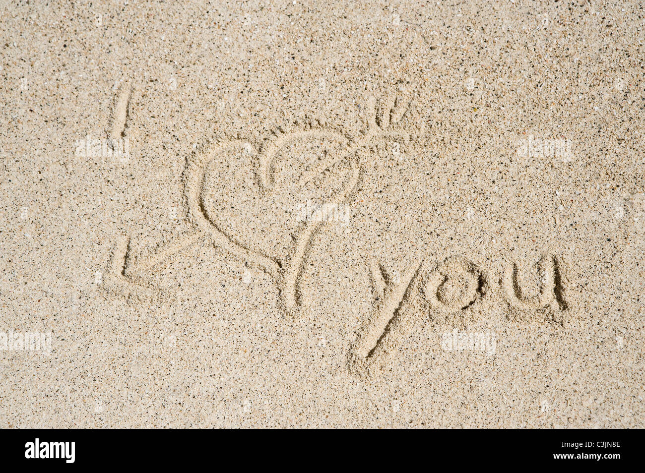 Asia, Indonesia, West Papua, Raja Ampat Islands, I love you text with heart shape written in Sand Stock Photo