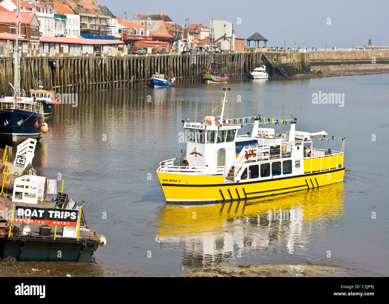 Tourist boat returning to mooring in Whitby harbour north Yorkshire England Europe Stock Photo