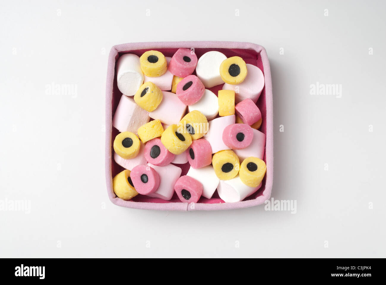 Marshmallows and Liquorice Allsorts framed in pink box Stock Photo