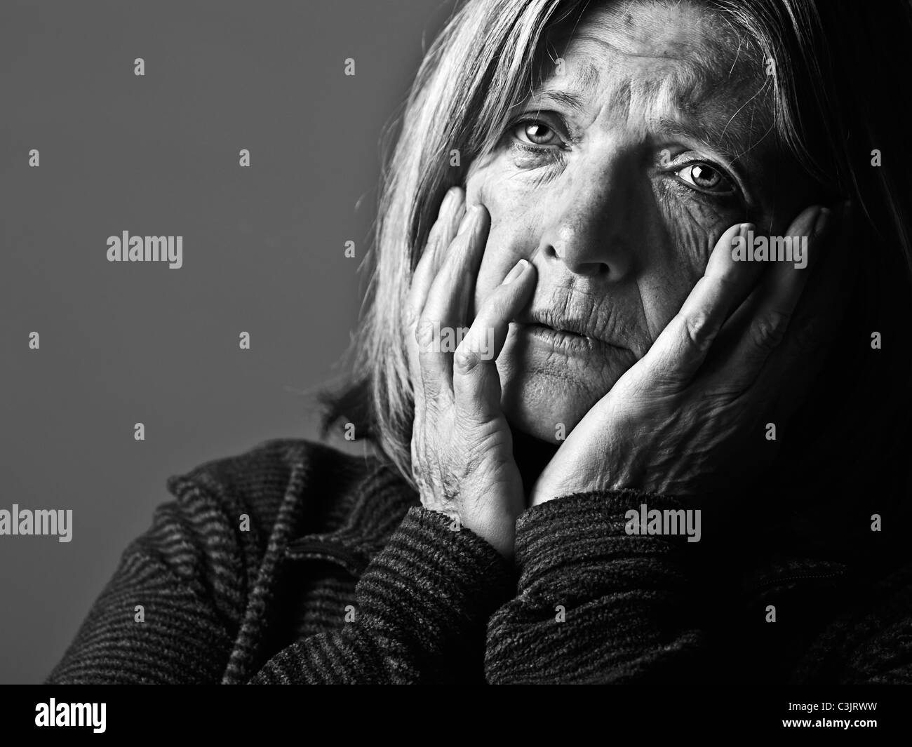 Studio portrait of sad senior woman Stock Photo