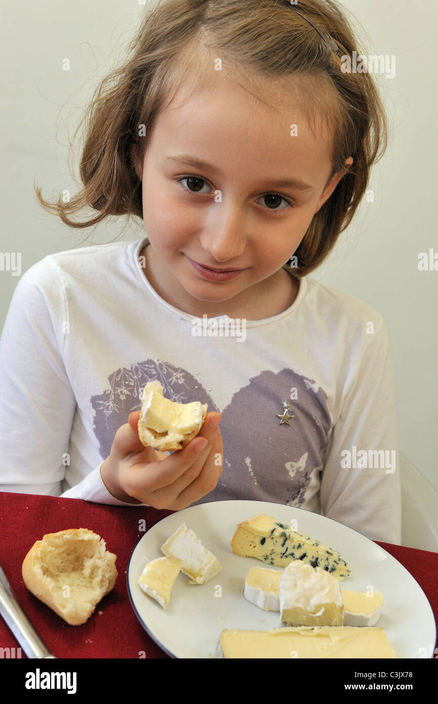 Young french girl (8) having cheese at lunch Stock Photo
