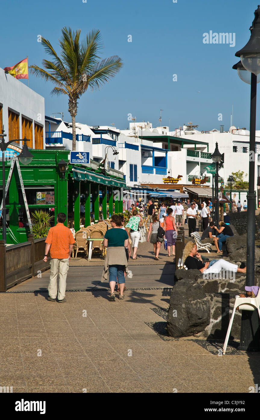 dh promenade PLAYA BLANCA LANZAROTE Tourist people walking holiday seafront promenade Stock Photo
