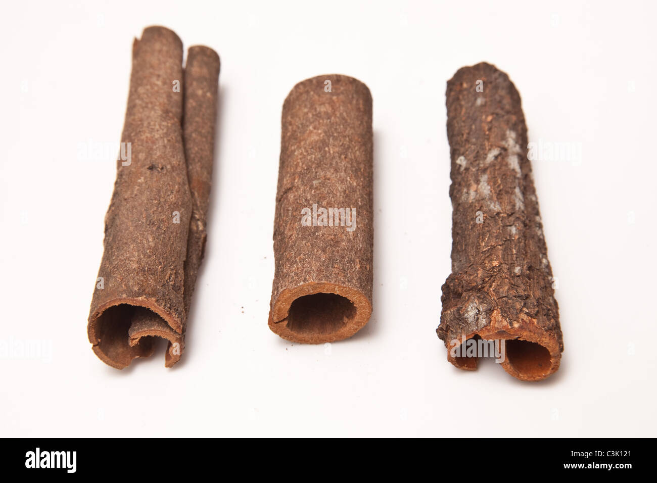 Cinnamon bark sticks isolated on a white studio background Stock Photo