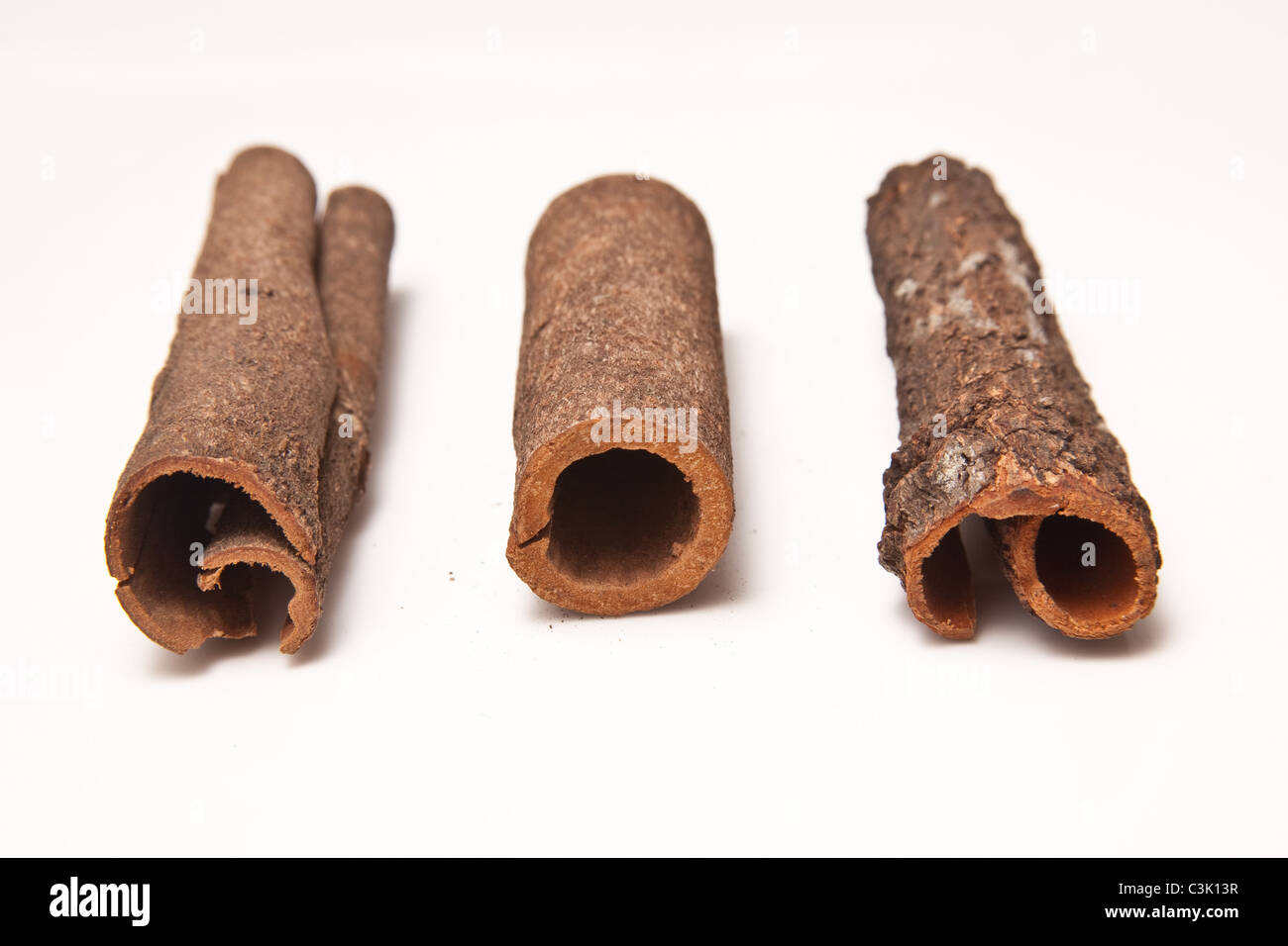 Cinnamon bark sticks isolated on a white studio background Stock Photo