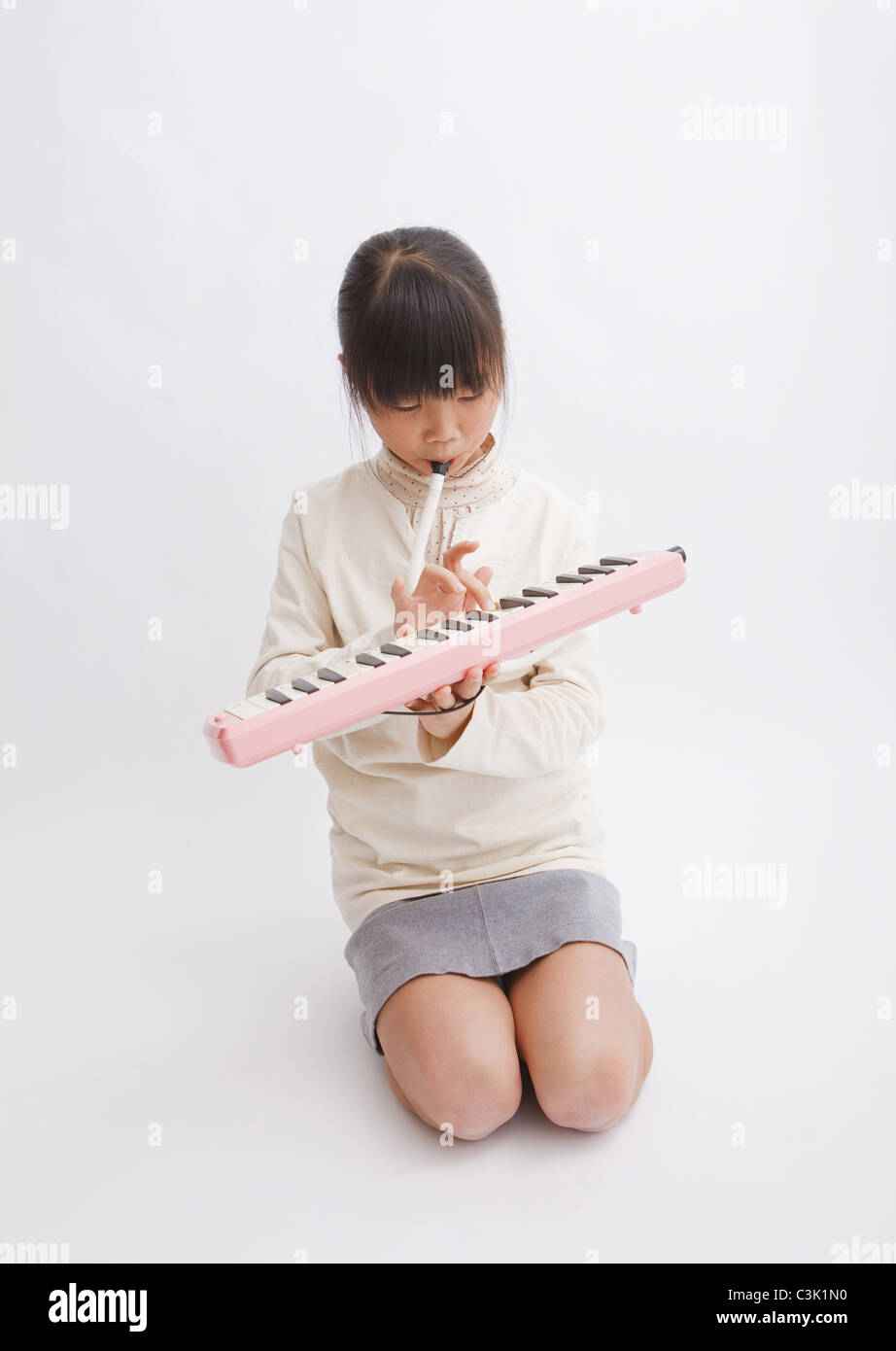 Girl playing the melodica Stock Photo Alamy