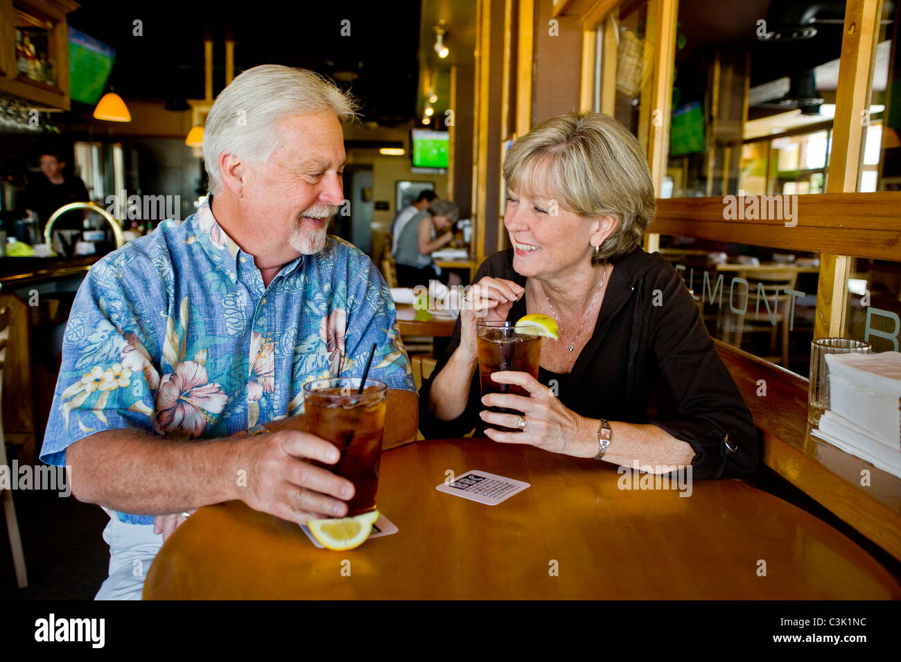 A happy middle aged married couple enjoy iced tea together in a Long Beach, CA, restaurant. MODEL RELEASE Stock Photo