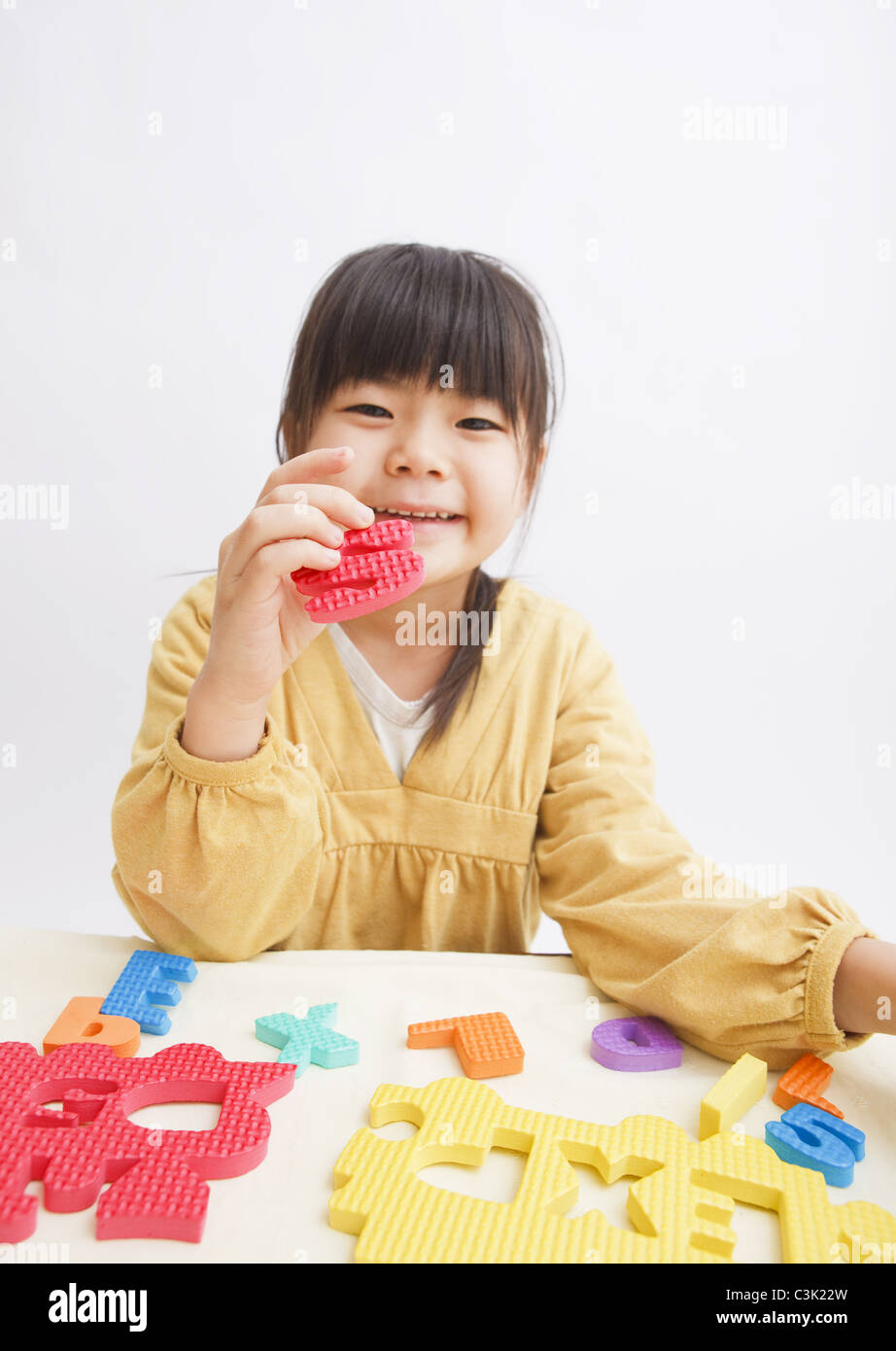 Girl playing puzzle Stock Photo Alamy