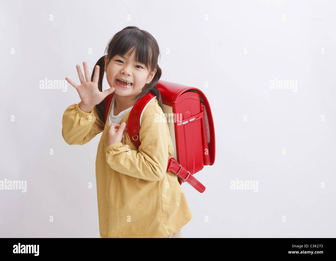 Girl carrying school bag Stock Photo