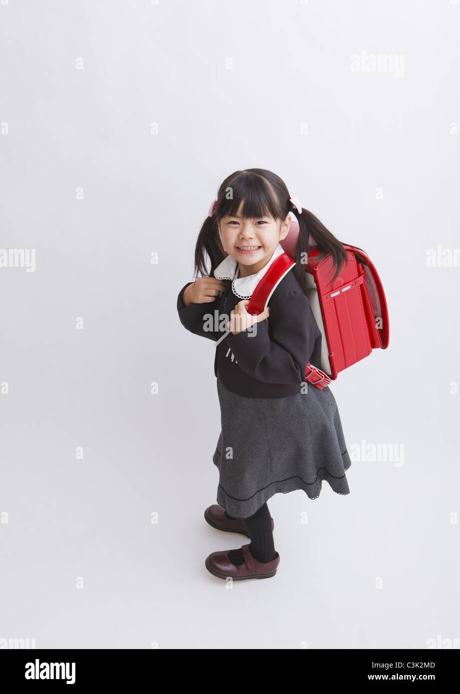 Girl carrying school bag Stock Photo Alamy
