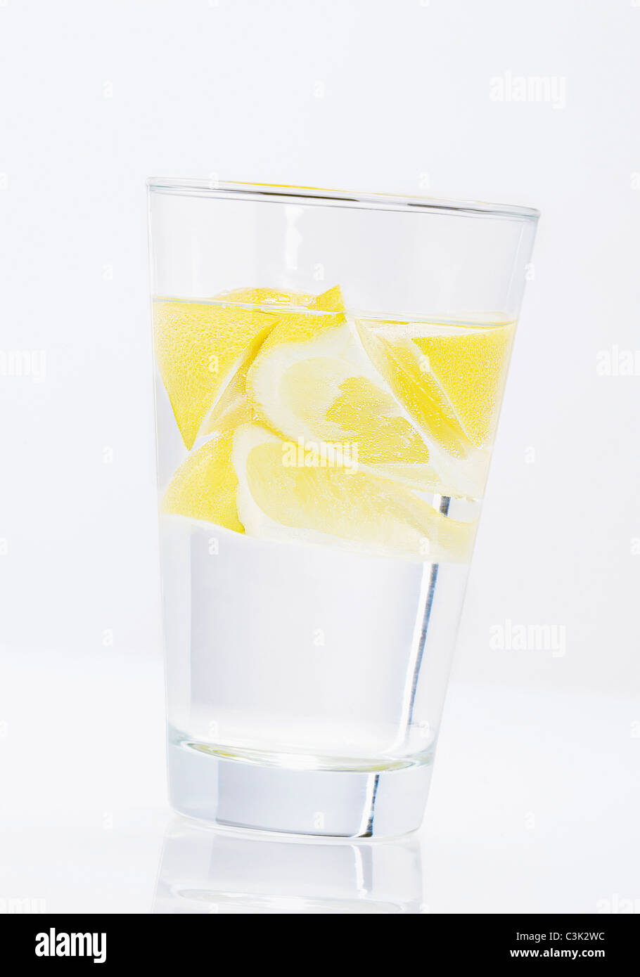 Glass of water with lemon slices on white background Stock Photo