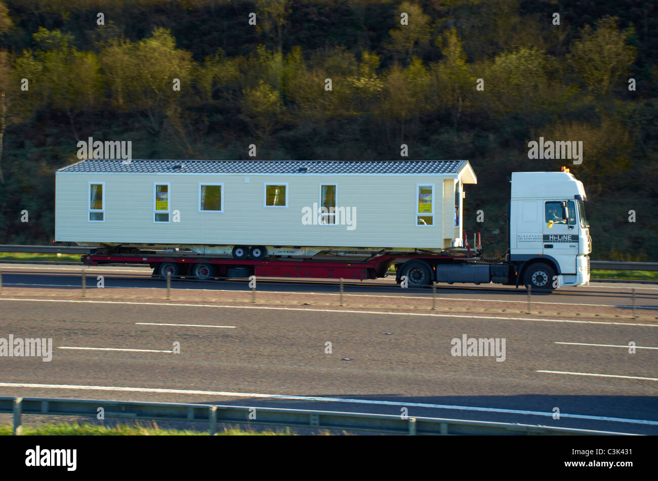 static caravan / holiday home on the back of a lorry Stock Photo