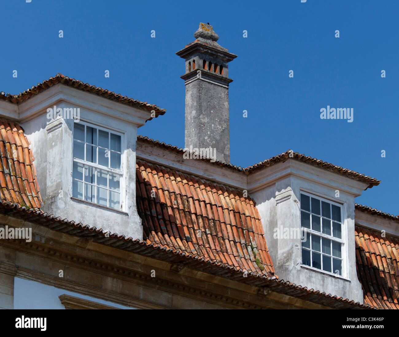Two roof windows and a chimney Stock Photo