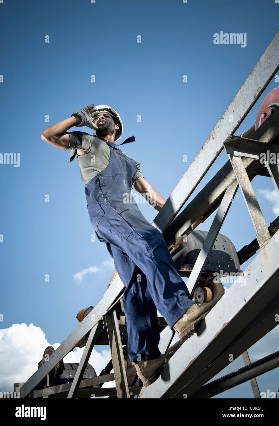 Germany, Augsburg, Worker calling from steel construction Stock Photo