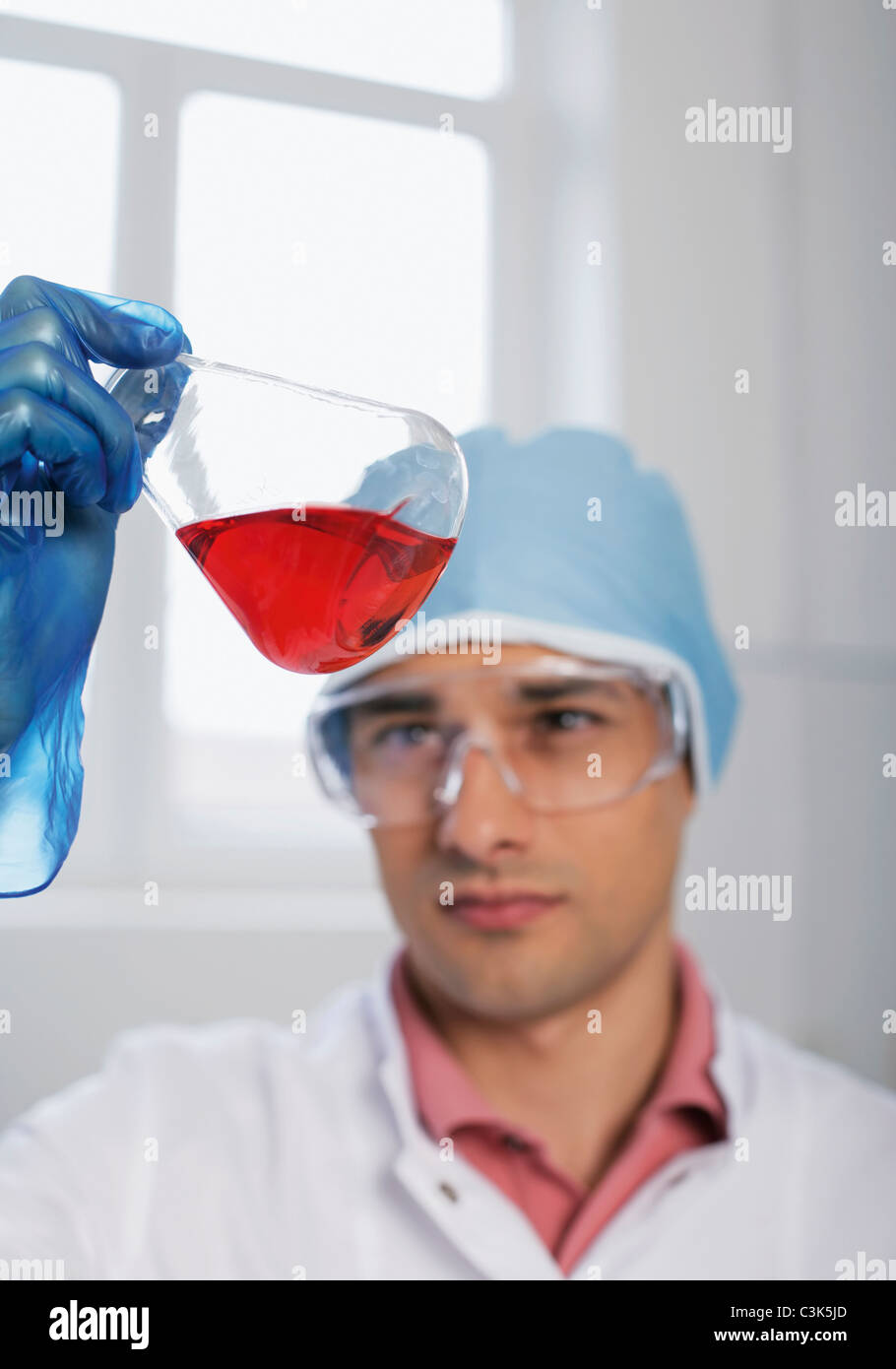 Romania,Bucharest, Laboratory technician with glass flask Stock Photo