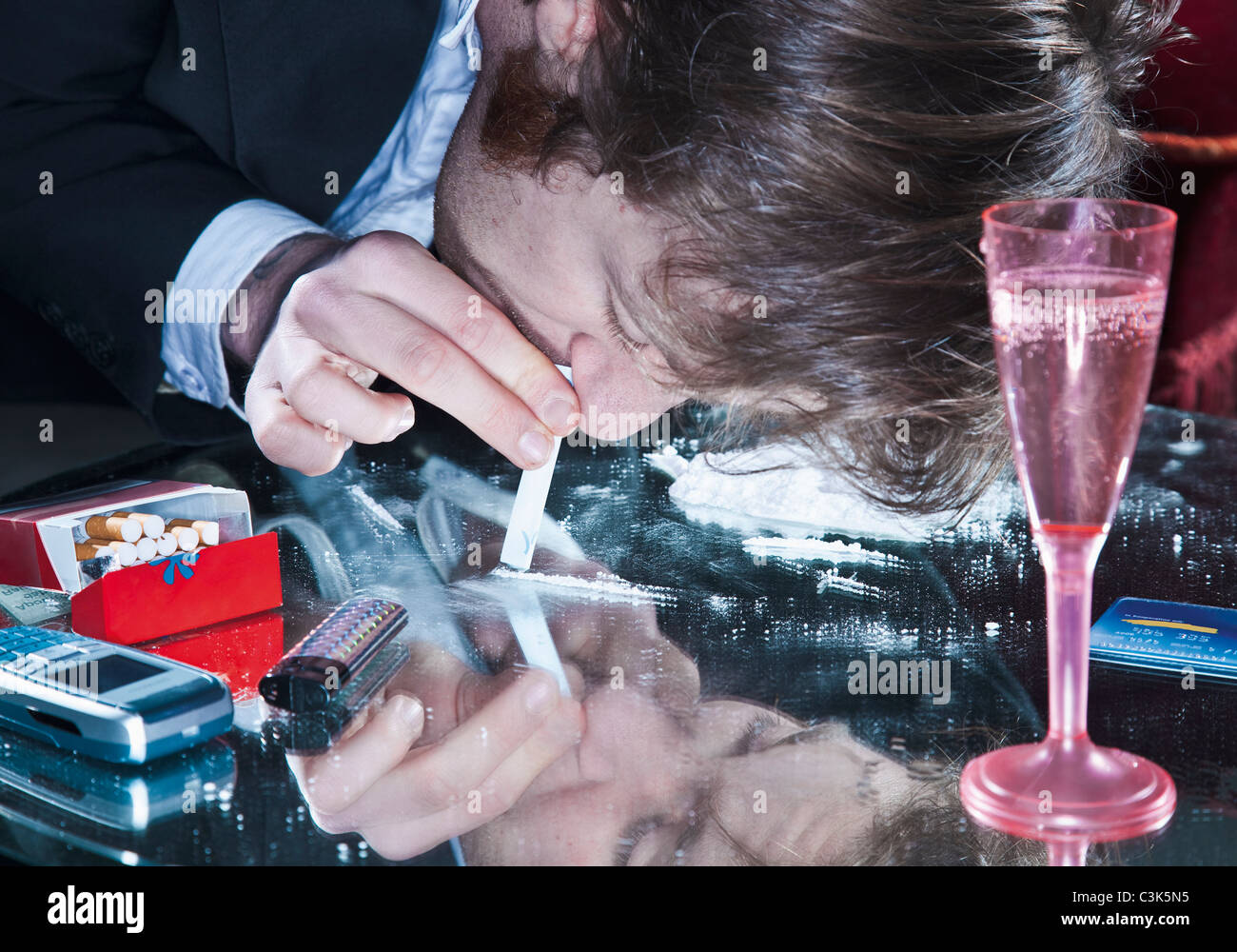 Young man sniffing cocaine Stock Photo