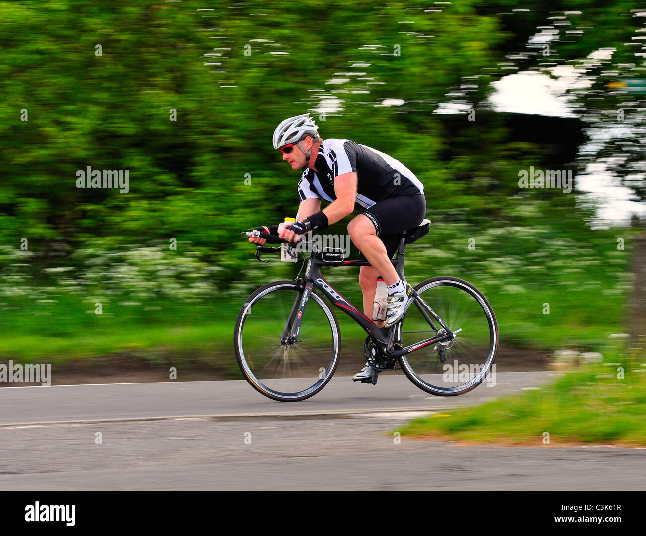 Cyclist moving fast on racing bicycle in Bedfordshire Stock Photo