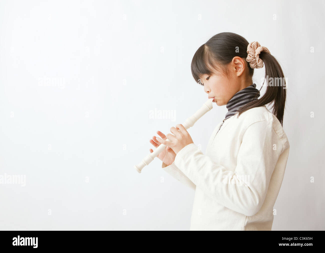 Girl playing recorder Stock Photo Alamy